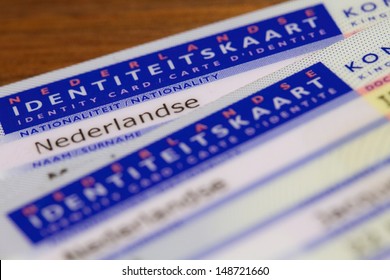 Two Dutch ID Cards On A Table