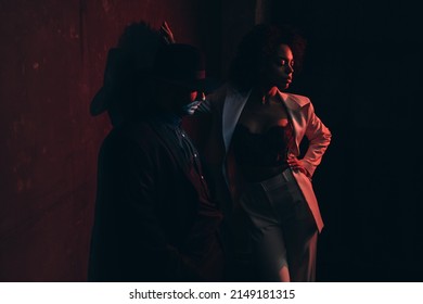 Two Dynamic Teenagers In Posh Attire Performing Vogue Dance In Loft Studio, Apartment Or Night Club Lit By Pink And Blue Neon Lights. 