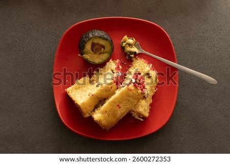 Two Easter cakes and avocado on a red plat