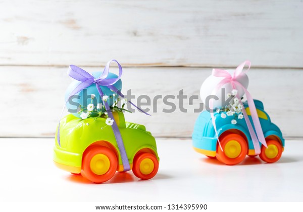 Two Easter cars with an egg and a car with the
inscription 