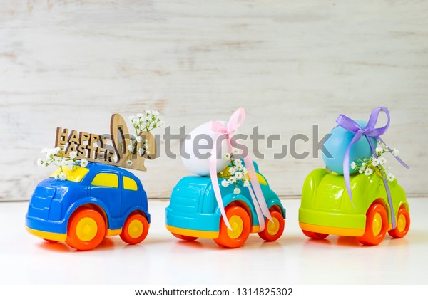 Two Easter cars with an egg and a car with the\
inscription \