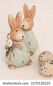 Two Easter rabbits, two eggs on white background. Easter composition, copy space