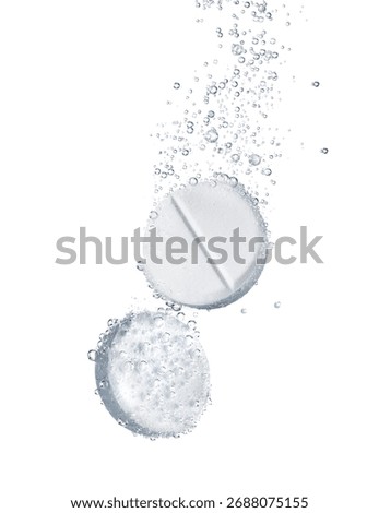 Two effervescent tablets fizz and dissolve on a white background, creating a dynamic visual effect with air bubbles.