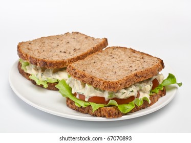 Two Egg Salad Sandwiches On Brown Toasted Bread