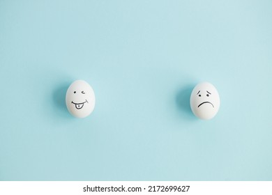 Two Eggs and sad   funny face blue background