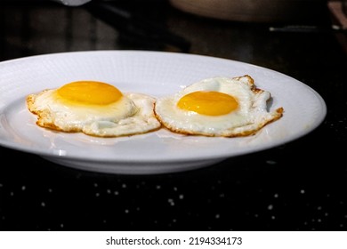 Two Eggs Sunny Side Up On A Plate