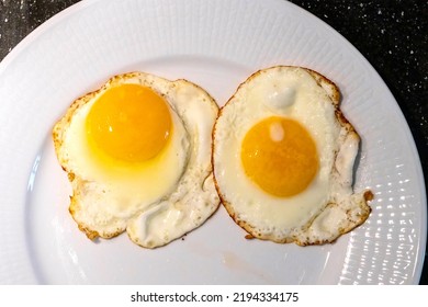 Two Eggs Sunny Side Up On A Plate