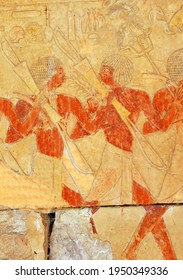 Two Egyptian Soldiers Carrying Bows And Clubs In The Early New Kingdom Mortuary Temple Of Queen Hatshepsut At Thebes In Egypt