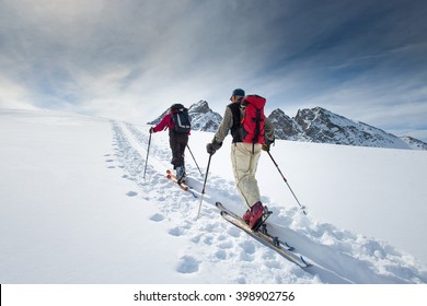 Two Elderly Alpine Skiers Climb On Skis And Sealskins