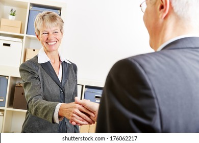 Two Elderly Business People Greeting With A Handshake At Job Interview