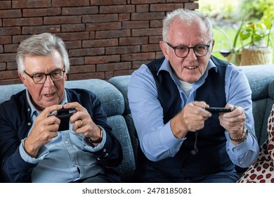 Two elderly men are enthusiastically playing video games, illustrating the joy of gaming at any age. - Powered by Shutterstock