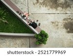 Two elderly people are sitting and sharing stories on a park bench in the morning. A social interaction of modern urban residents in Jakarta, Indonesia.