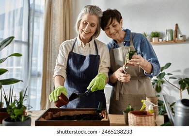 Two elderly women plant plants in the garden. - Powered by Shutterstock