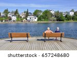 Two elderly women sitting on the wooden bench in boardwalk