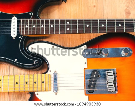 two electric guitars with wod background