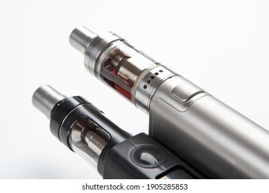 Two Electronic Cigarette Close-up. Fragment Of Electronic Cigarette On A White Background. Vaping Cigarettes. Devices For Smoking Steam. Cigarettes Are Modern. Concept Devices From Vape Shop