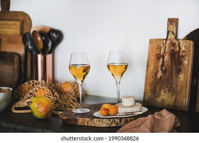 Two Elegant Glasses Of Orange Or Amber Wine And Appetizers