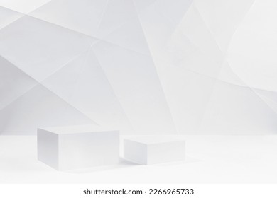 Two elegant white square podiums mockup on white table in soft light white interior with lines, angles in geometric modern style for presentation cosmetic products, goods, branding, design.