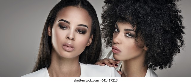 Two elegant young african american women posing together.