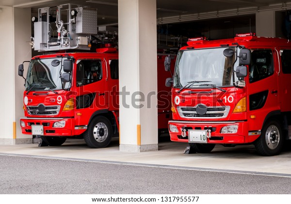 two\
emergency fire service vehicles stand at the\
station