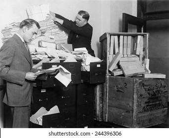 Two employees of the Federal Radio Commission overwhelmed by piles of mail in 1929. Federal Radio Commission was established in 1926 to end chaos caused by broadcasters competition for radio waves.