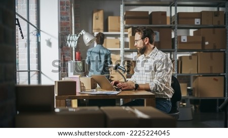 Two Employees Preparing Working on Orders Made from Online Store Sales. Man and Female Working in a Storeroom. Man Using Laptop Computer, Black Woman Packing the Items in Cardboard Boxes.