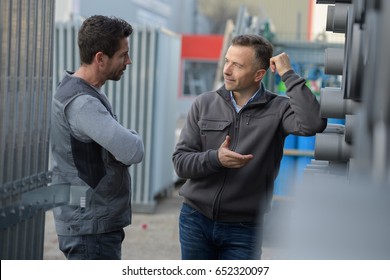 Two Employees Working In Factory