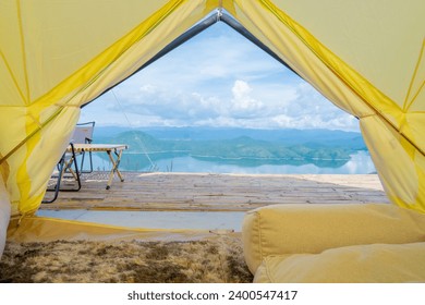 Two Empty Camping Chairs Standing on the Top of the Mount. Perfect Place for Watching Sunset. Actice Relaxation Lifestyle, Tourist tent in camp among with mountain view on sunrise, Travel vacation.
