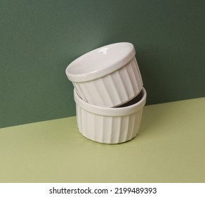 Two Empty Ceramic Bowl On Green Two Tone Green Background