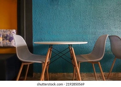 Two Empty Chairs At A Table In A Modern Cafe. Front View For Product Presentation With Copy Space. No People