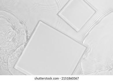 Two empty clear white square podiums on transparent calm water texture with splashes and waves in sunlight. Abstract nature background for product presentation. Flat lay cosmetic mockup, copy space. - Shutterstock ID 2151860367