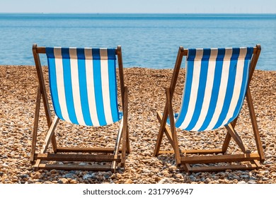Two empty deck chairs on brighton Beach, on a sunny summer's day
