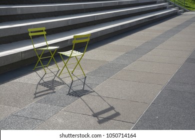 Two Empty Green Chairs Facing Each Other 