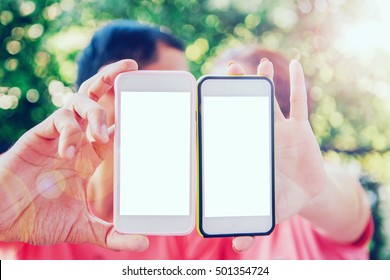 Two Empty Mobile Phones Together On Couple Hands. Love Or Wedding Or Valentine Concept. Vintage Filtered.