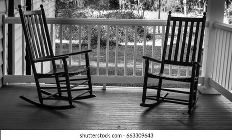 Two Empty Rocking Chairs. Two wooden rocking chairs on a front porch on a warm summer evening.