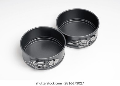 Two empty springform cake tins isolated on white background