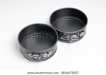 Two empty springform cake tins isolated on white background