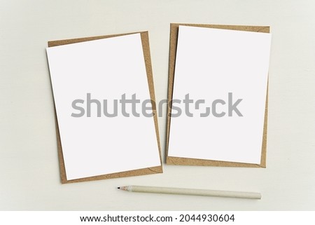 Two empty white notecards on brown kraft paper envelopes, set of 2 greeting cards, postcards mockup for design presentation.