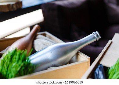 Two empty wine bottles lying in wooden box. Composition with wine bottles and green grass. Space for copy text - Powered by Shutterstock