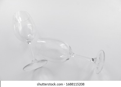 Two Empty Wine Glass Lay On White Table Above View