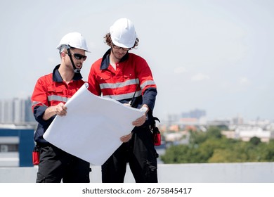 Two engineer checking solar energy system looking blueprint together for planning installation solar panel, renewable energy and sustainable technology, clean electricity, industry and solar cell.