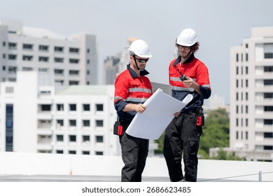 Two engineer checking solar energy system looking blueprint together for planning installation solar panel, renewable energy and sustainable technology, clean electricity, industry and solar cell.