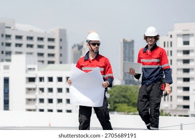 Two engineer checking solar energy system looking blueprint together for planning installation solar panel, renewable energy and sustainable technology, clean electricity, industry and solar cell.