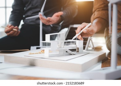 Two Engineer Design Professionals Discussion About Calculate To Use Pure Energy Nature And Installing Solar Panels On Roof House To Generate Electricity Working With Model, And Solar Panel Sample