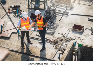 Two engineer in hardhat and orange jacket posing on building site. civil engineer or architect with hardhat on construction site checking schedule on plan. Two business man construction site engineer. - Shutterstock ID 2192484171