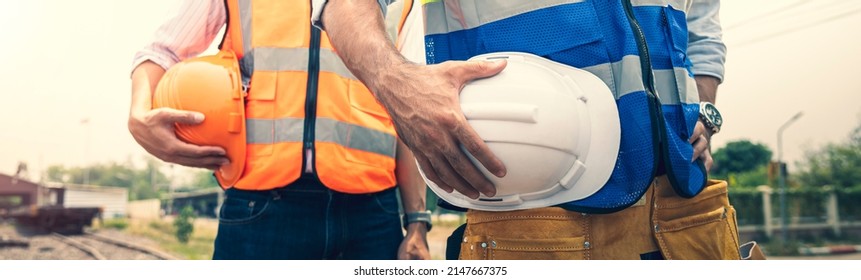 Two engineer holding helmet standing in row on site work, banner cover design. - Shutterstock ID 2147667375