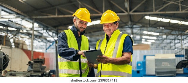 two engineer look projects and planning with tablet mobile in factory - Powered by Shutterstock