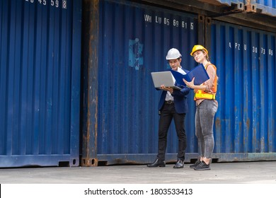 two engineer worker hold a laptop, document for checking a quality of containers box from cargo ship for export and import, blue container background