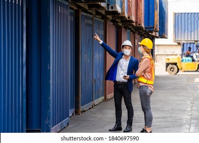 two engineer worker hold a laptop, document for checking a quality of containers box from cargo ship for export and import, blue container background