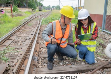Two engineer working at train station,Work together happily,Help each other analyze the problem,Consult about development guidelines